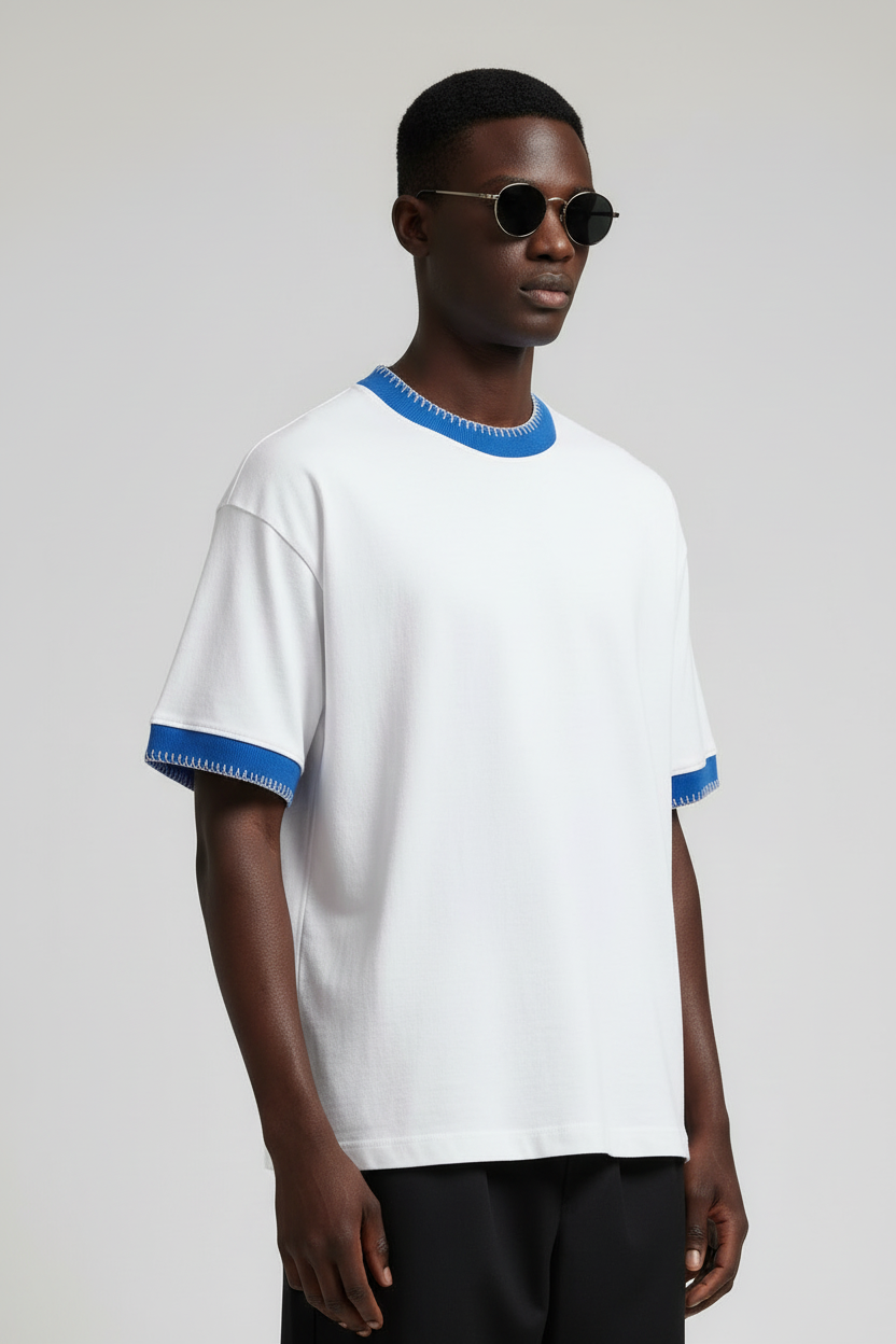 Man wearing a white t-shirt with blue accents on a plain background